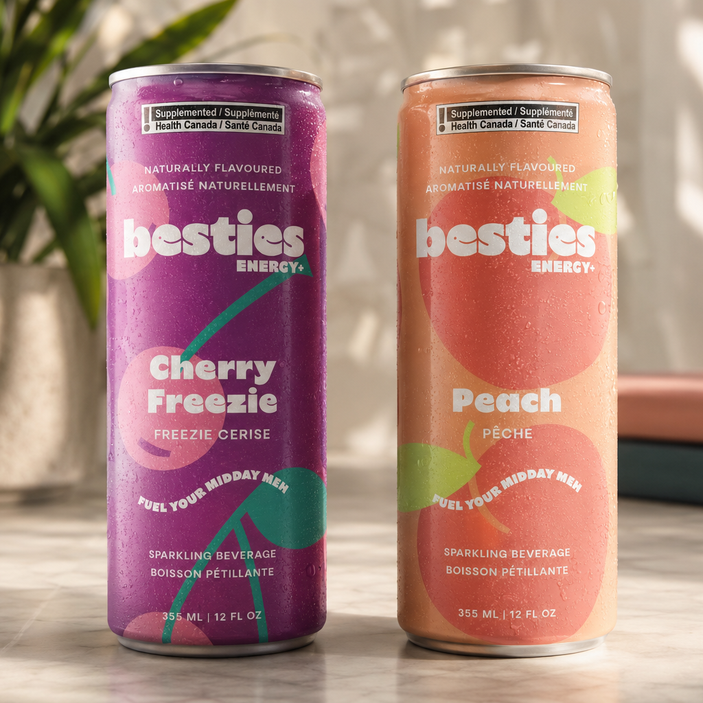 Two cans of besties energy drinks, one cherry freezie and one peach, on a surface.